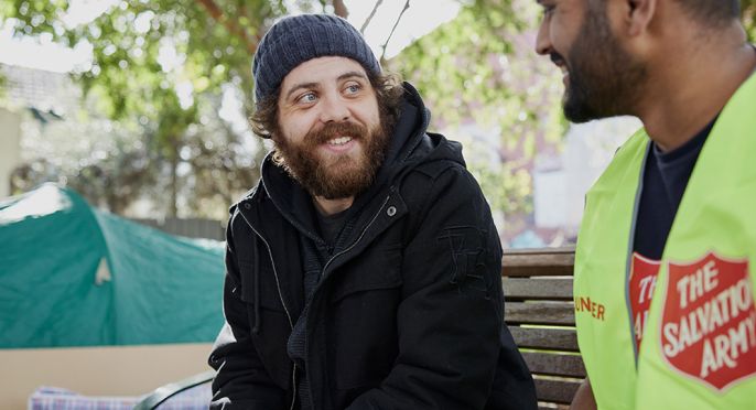 Salvation army personnel providing help to an individual